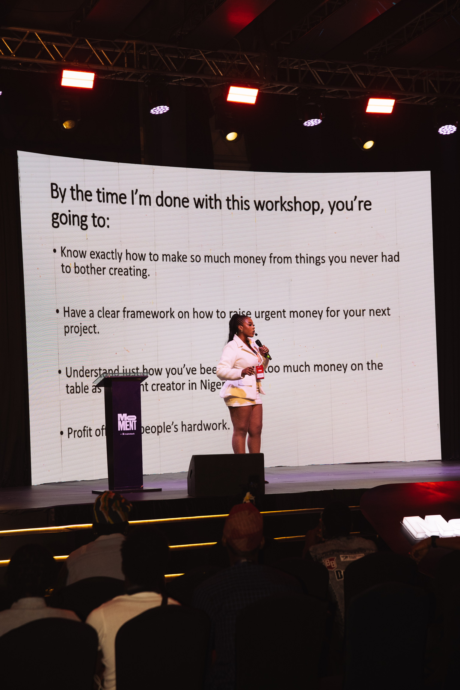 Anna speaking on stage at the Moment by Mainstack event in Lagos
