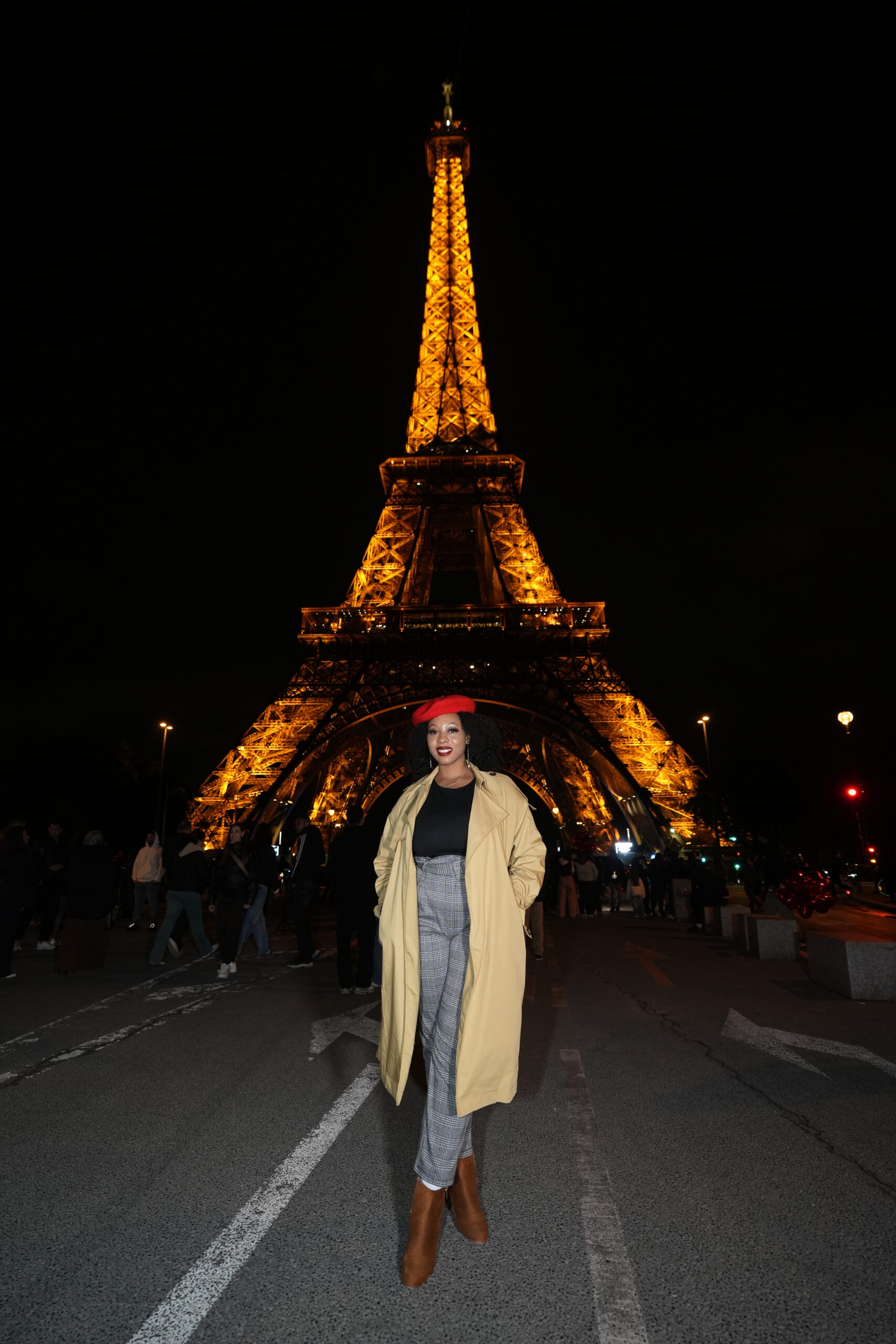 Anna on vacation in Paris in front of the Eiffel Tower at night